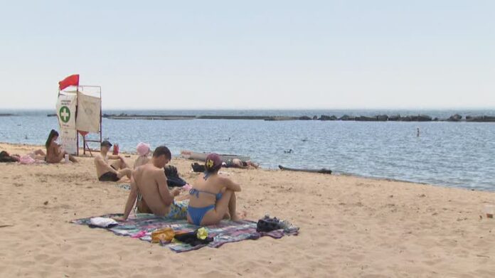 beach8-featured 多倫多湖濱泳灘夏季開放,有泳客在沙灘休息,附近設有救生員崗位。