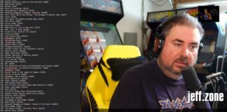 A man with brown hair sits in a garage full of video game paraphernalia. A running list of video game titles is seen, taken from a computer screen, on the left side.