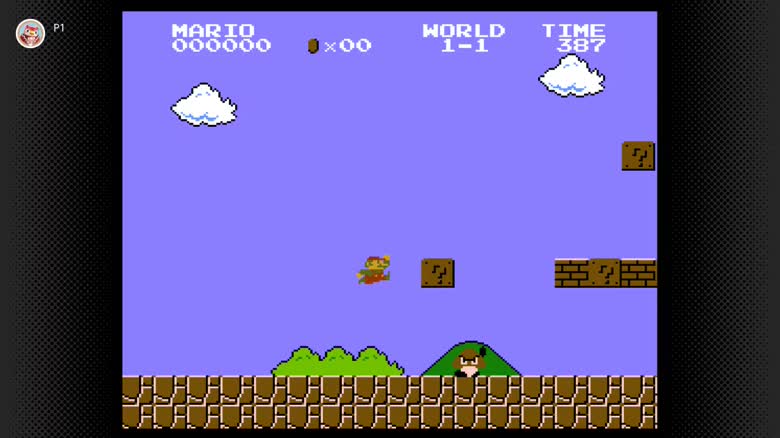 Screenshot of an 8-bit video game with Mario jumping in the air.
