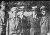 A news paper photo of five people posing in front of a newspaper office.
