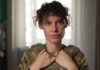 This officer with the National Guard of Ukraine goes by the call sign 'Kudriava.' She was issued standard body armour designed for men, but over the years she's bought her own because it fits better. (Serhii Moos/CBC)
