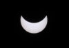 A black sky with a bright white moon.