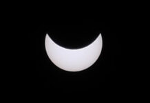 A black sky with a bright white moon.