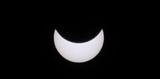 A black sky with a bright white moon.