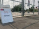 A closure sign in front of a fenced off splash pad