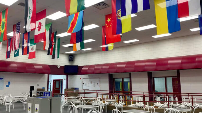 Flags are seen in a cafeteria.