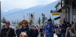 People on a street with mountains.