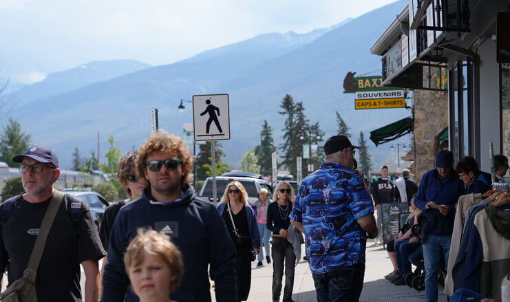 People on a street with mountains.