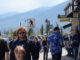 People on a street with mountains.