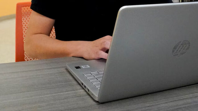 A 2023 file photo of someone working on a laptop.