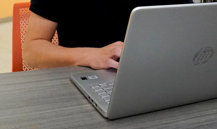 A 2023 file photo of someone working on a laptop.