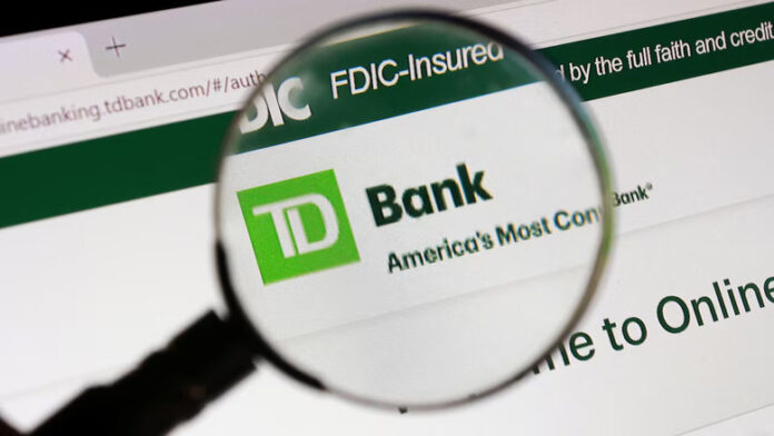 A magnifying glass over a TD Bank logo on a computer screen.