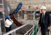 Prime Minister Mark Carney looks over a 212A class submarine under maintenance as he tours the ThyssenKrupp Marine Systems submarine-building facility in Kiel, Germany, in August 2025. (Christinne Muschi/The Canadian Press)