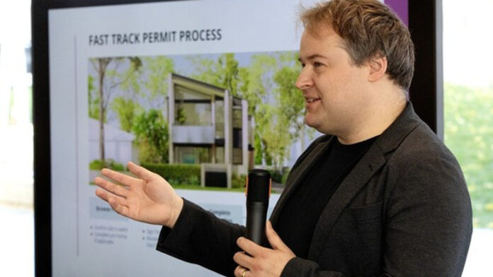 Greg Whistance-Smith, Project architect with City of Edmonton's Infrastructure Services leads a panel discussion about infill housing at Edmonton's Stanley Milner Library, Thursday Oct. 15, 2026. Photo by David Bloom