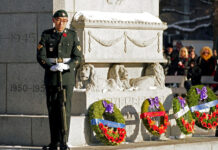 Morgan Xishen Wong stands guard at the cenotaph in front of Edmonton City Hall during a Remembrance Day ceremony on Nov. 11, 2022. Photo by Larry Wong / Postmedia
