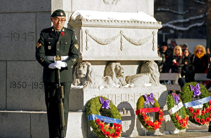 Morgan Xishen Wong stands guard at the cenotaph in front of Edmonton City Hall during a Remembrance Day ceremony on Nov. 11, 2022. Photo by Larry Wong / Postmedia
