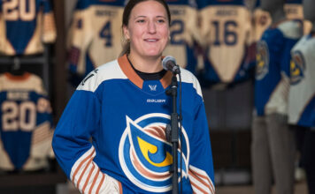 The Vancouver Goldeneyes' Jenn Gardiner is seen with the team's new jersey for the upcoming 2026-27 season on Wednesday. (Hunter Soo/CBC) 圖片來源：Hunter Soo/CBC